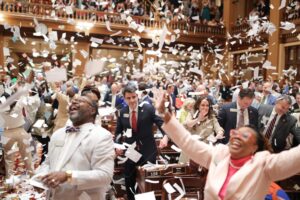 People throwing paper into the air to celebrate Sine Die 2026