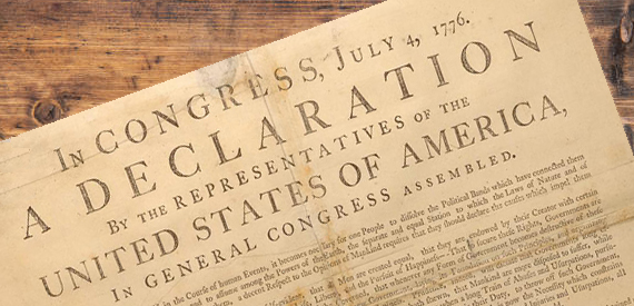 The Declaration of Independence on top of a wooden table.